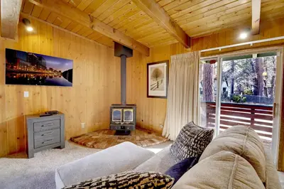 a living room with a couch and a stove at Switzerland ski chalet #845 in Big Bear Lake
