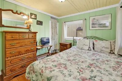 a bedroom with a bed and a dresser and a window at Pines 23 #1438 in Big Bear Lake