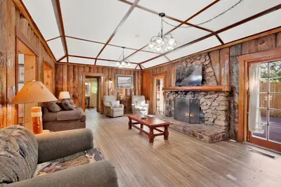 a living room with a stone fireplace in a house at Lodge house #100 in Big Bear Lake