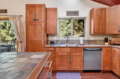 a kitchen with wooden cabinets and a counter top at Top Notch Lodge#2056 in Big Bear Lake