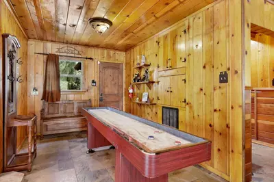 a pool table in a room with wooden walls at Top Notch Lodge#2056 in Big Bear Lake
