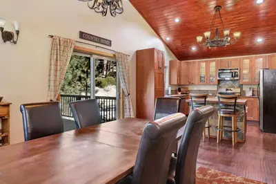 a kitchen and dining room with a wooden table and chairs at Top Notch Lodge#2056 in Big Bear Lake