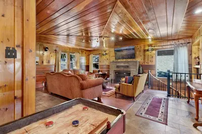 a living room with a pool table in a house at Top Notch Lodge#2056 in Big Bear Lake