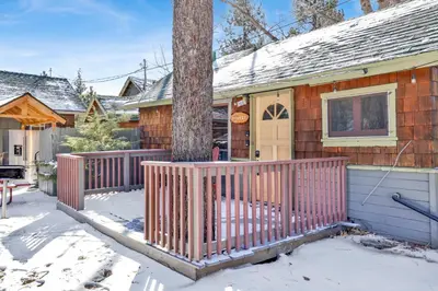 a house with a wooden fence in the snow at Sunset #101 in Big Bear Lake