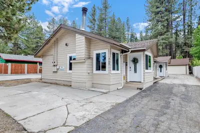 a small white house with a driveway at Sweet retreat 1 #2332 in Big Bear Lake
