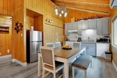 a kitchen with a table with chairs and a refrigerator at Sweet retreat 1 #2332 in Big Bear Lake