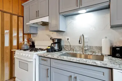 a kitchen with white cabinets and a sink at Sweet retreat 1 #2332 in Big Bear Lake