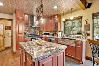 a kitchen with wooden cabinets and a granite counter top at How sweet it is #1531 in Big Bear Lake