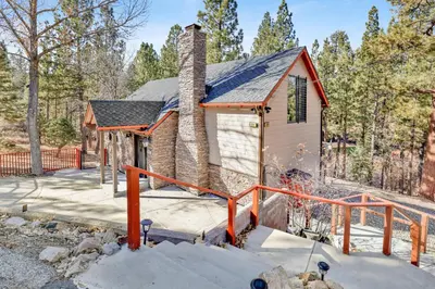 a small house with a brick chimney in the snow at How sweet it is #1531 in Big Bear Lake