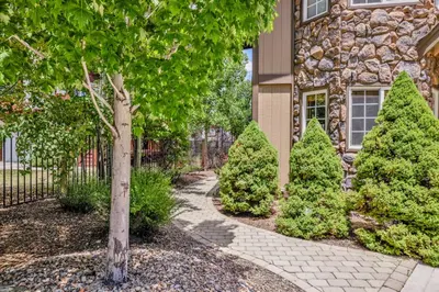 a walkway in front of a house with trees at Lakefront village castle #2312 in Big Bear Lake
