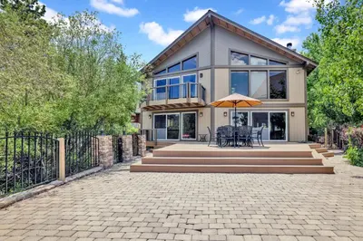 a house with a patio with tables and an umbrella at Lakefront village castle #2312 in Big Bear Lake