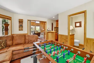a living room with a couch and a foosball table at Lakefront village castle #2312 in Big Bear Lake