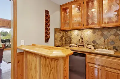 a kitchen with wooden cabinets and a sink at Lakefront village castle #2312 in Big Bear Lake