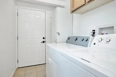 a kitchen with white appliances and a white door at Beary cozy cabin #2315 in Big Bear Lake