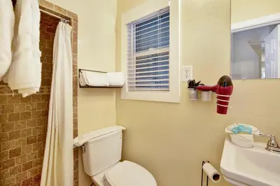 a bathroom with a toilet and a sink and a window at Beary cozy cabin #2315 in Big Bear Lake