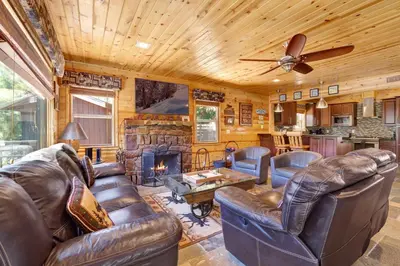a living room with leather furniture and a fireplace at Circle views #1602 in Big Bear Lake