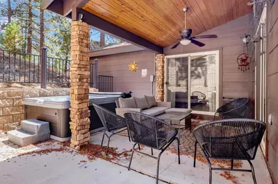 a patio with chairs and a hot tub at Circle views #1602 in Big Bear Lake
