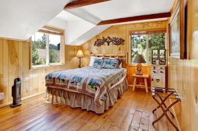 a bedroom with a bed in a room with wooden walls at Circle views #1602 in Big Bear Lake