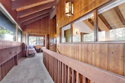 a hallway of a house with wooden walls and windows at Lakeview fishing house #121 in Big Bear Lake