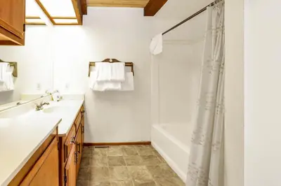 a bathroom with a tub and a sink and a shower at Lakeview fishing house #121 in Big Bear Lake