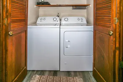 a kitchen with a stove and a washer and dryer at Lakeview fishing house #121 in Big Bear Lake