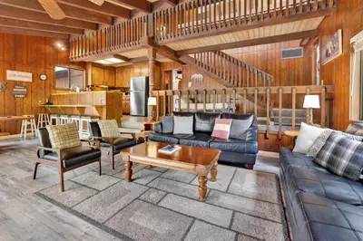 a living room with a couch and a table at Lakeview fishing house #121 in Big Bear Lake