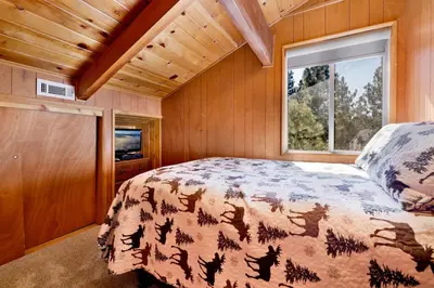 a bedroom with a bed and a window at Moose creek chalet #1237 in Big Bear Lake