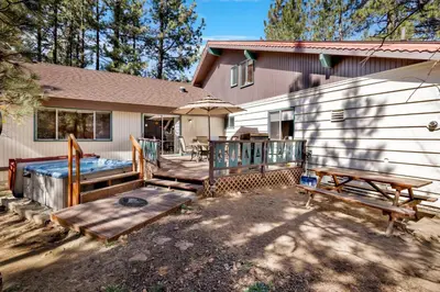 a house with a deck and a hot tub at Moose creek chalet #1237 in Big Bear Lake