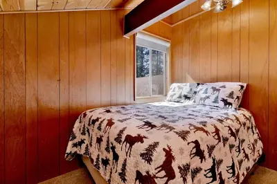 a bedroom with a bed and a window at Moose creek chalet #1237 in Big Bear Lake