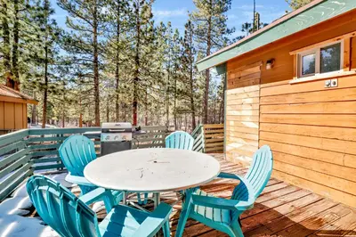 a table and chairs on the deck of a cabin at Vista pines #234 in Big Bear Lake