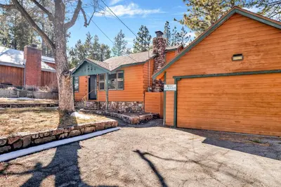 an orange house with a garage and a tree at Vista pines #234 in Big Bear Lake