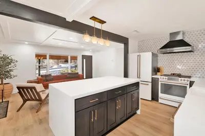 a kitchen with a white counter top and a living room at Vista pines #234 in Big Bear Lake