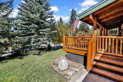 a porch of a cabin with an american flag at Knotty and nice #177 in Big Bear Lake