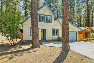 a house in the woods with trees at Blue bear chalet #2045 in Big Bear Lake