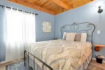 a bedroom with a bed with blue walls at Blue bear chalet #2045 in Big Bear Lake
