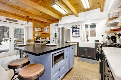 a kitchen with a large island with a black counter top at Blue bear chalet #2045 in Big Bear Lake