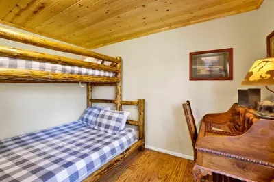 a bedroom with two bunk beds and a desk at Cove lakefront chalet #2098 in Big Bear Lake