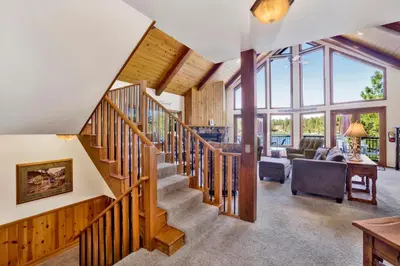 a staircase in a house with a living room at Cove lakefront chalet #2098 in Big Bear Lake