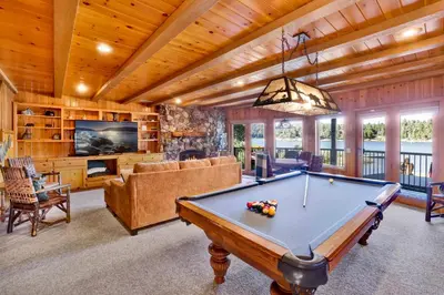 a pool table in a living room with a tv at Cove lakefront chalet #2098 in Big Bear Lake