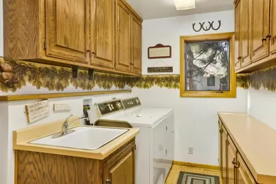 a kitchen with a sink and a washing machine at Cove lakefront chalet #2098 in Big Bear Lake
