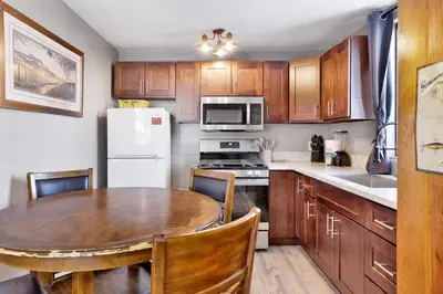 a kitchen with a table and a white refrigerator at Shore acres lodge #450 in Big Bear Lake