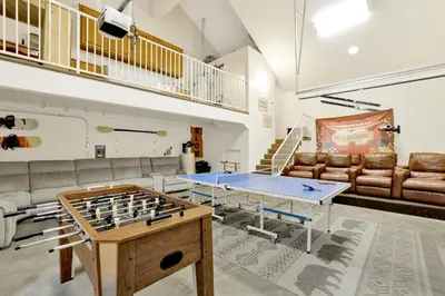 a living room with a ping pong table and couch at The spa at winterset #2282 in Big Bear Lake