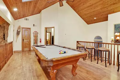 a pool table in a living room with a ceiling at The spa at winterset #2282 in Big Bear Lake