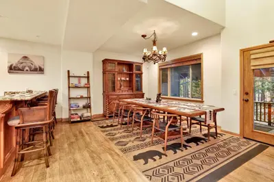 a dining room with a large wooden table and chairs at The spa at winterset #2282 in Big Bear Lake