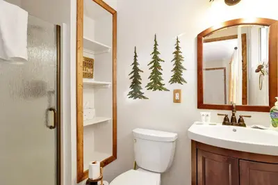 a bathroom with a toilet and a sink and a mirror at Mockingbird mountain getaway #2380 in Big Bear Lake
