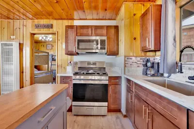 a kitchen with wooden cabinets and a stove top oven at Sunrise #108 in Big Bear Lake