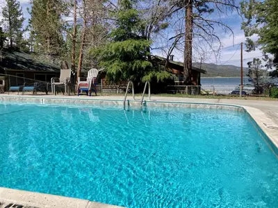 a swimming pool with blue water in front of a house at Sunrise #108 in Big Bear Lake