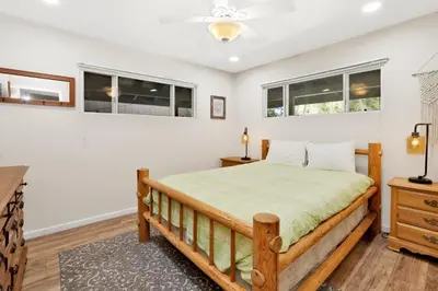 a bedroom with a bed and two windows at Cozy up to summit #1651 in Big Bear Lake