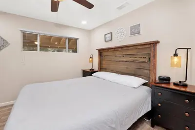 a bedroom with a white bed and a wooden dresser at Cozy up to summit #1651 in Big Bear Lake
