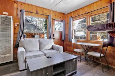a living room with a couch and a table at Juniper #105 in Big Bear Lake